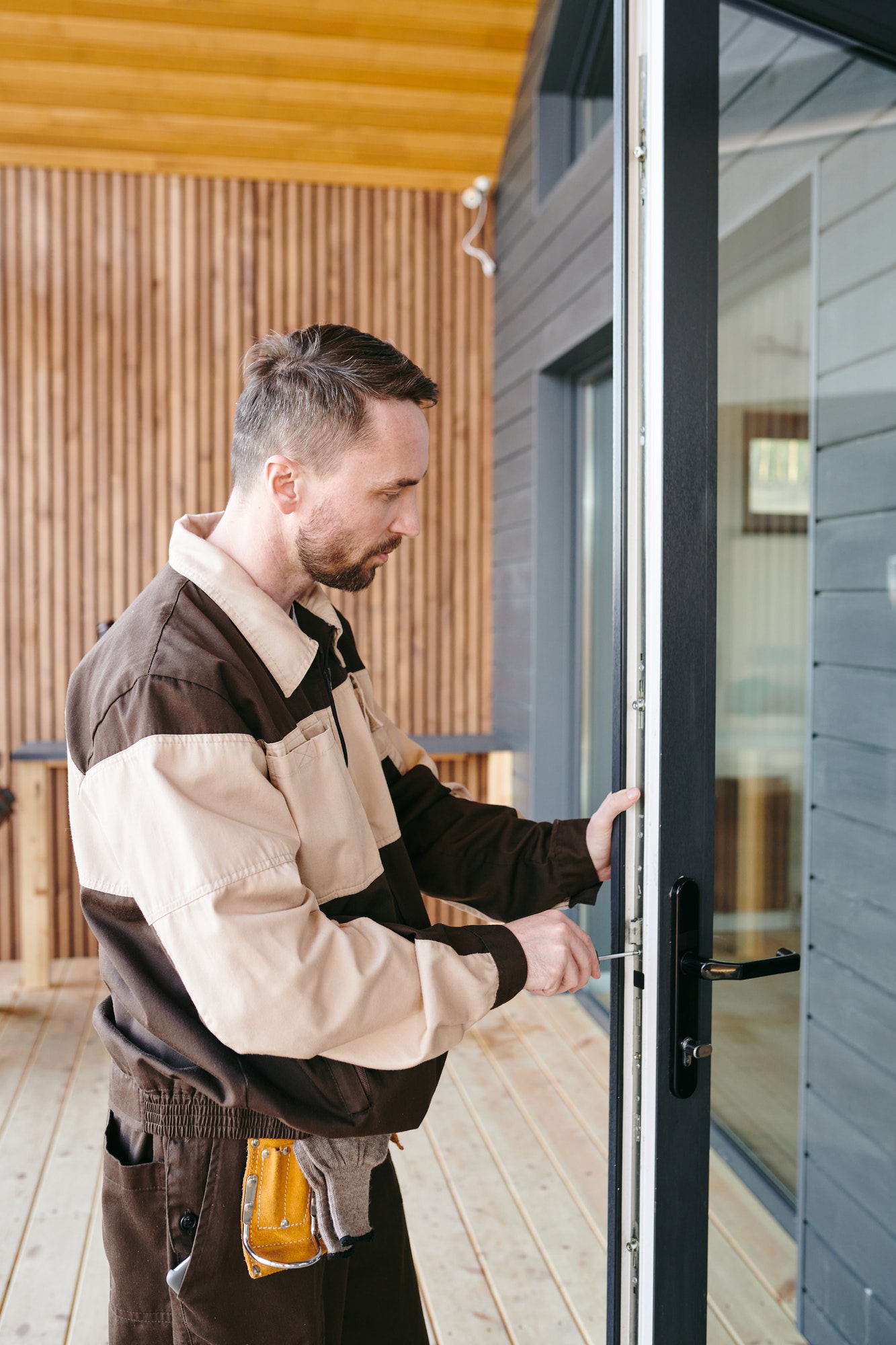 young-repairman-fixing-lock-in-large-transparent-door.jpg